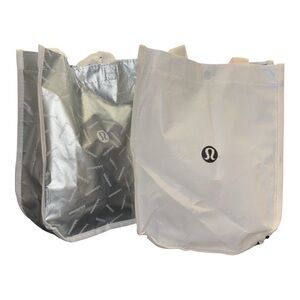 2 Lululemon reusable shoptotes, 1 black & white 2 silver recycled materials S4